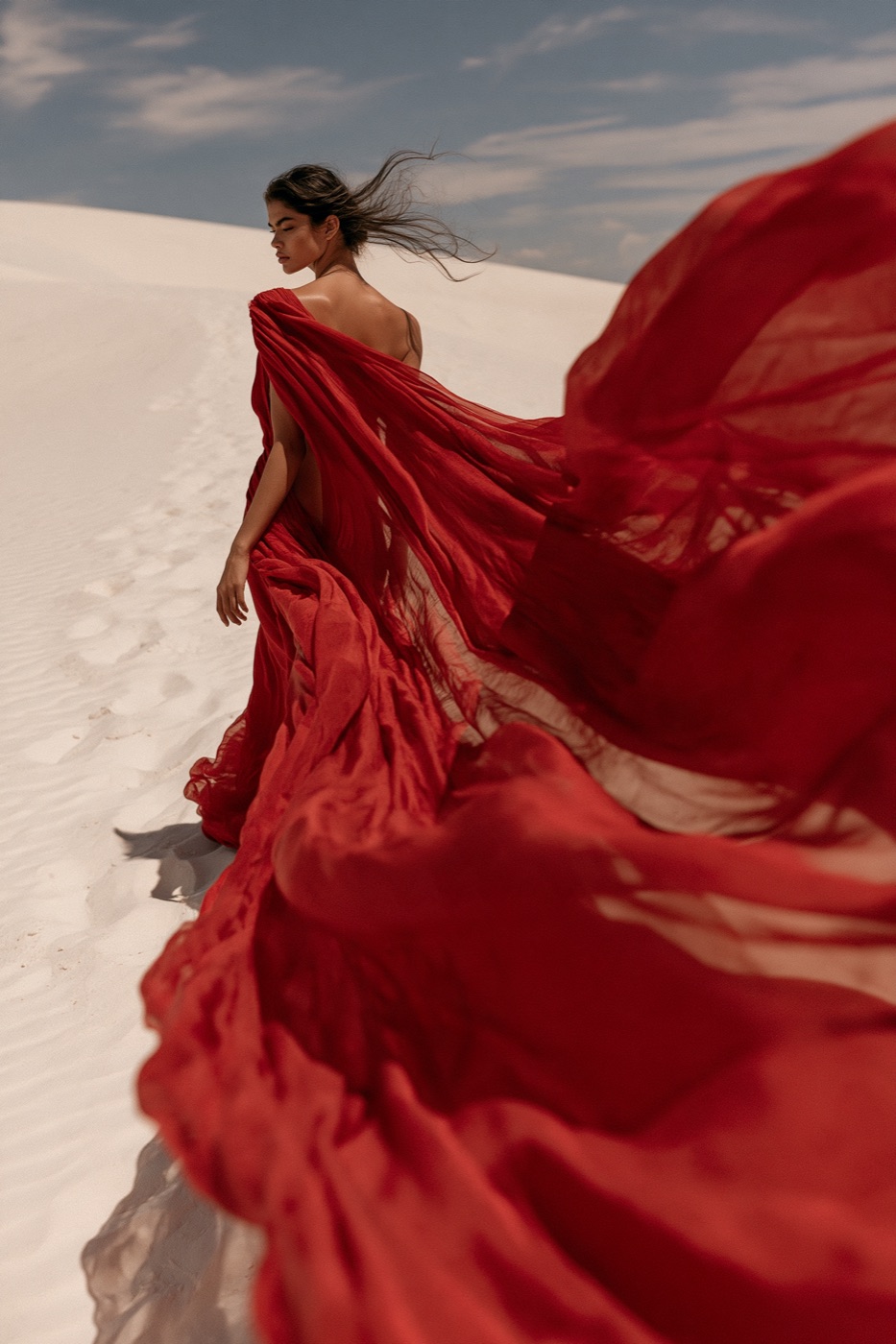 Variation 3 of 4 from one Midjourney V8 run: crimson gown on white dunes