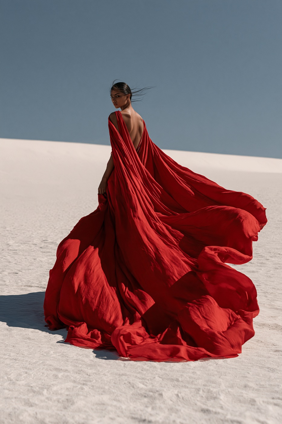 Fashion model in a flowing crimson silk gown on white sand dunes, Midjourney V8