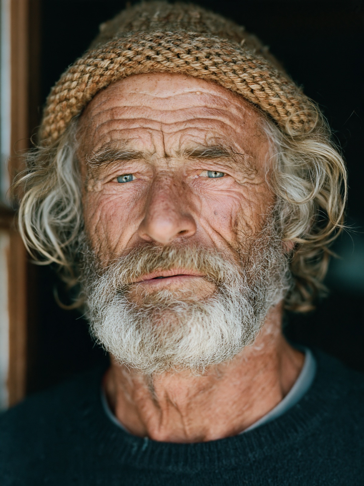 Close-up portrait of an elderly fisherman with a knitted cap and weathered skin, Midjourney V8